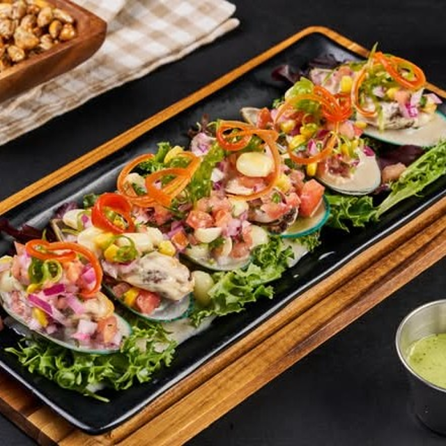 Choritos a la Chalaca (Mussels with Onion and Tomato Salsa).